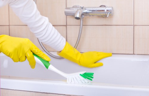 Cleaner working in an Acton home with a focus on tidy living spaces