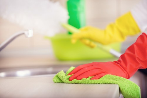 Cleaner preparing a tidy, well-kept living space in Acton